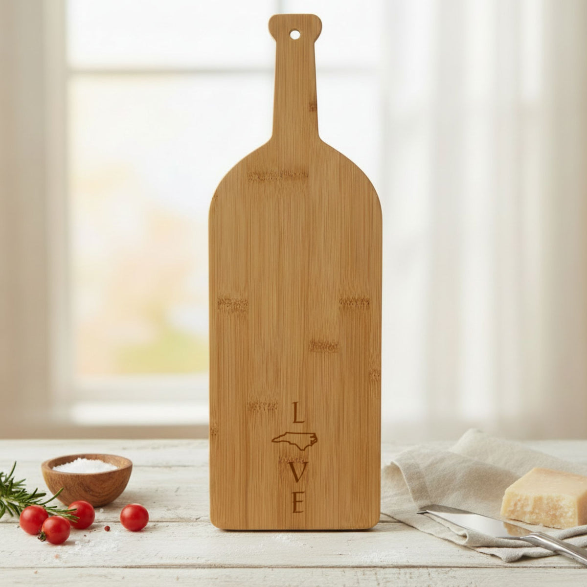 Bamboo wine bottle cutting board engraved with the North Carolina LOVE Stacked design