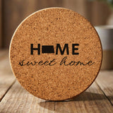 North Dakota round cork coaster engraved with HOME sweet home using the state shape as the letter O