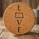 North Dakota round cork coaster engraved with LOVE stacked vertically using the state as the letter O