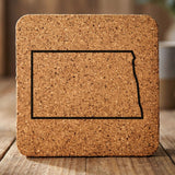 North Dakota square cork coaster engraved with a clean state outline