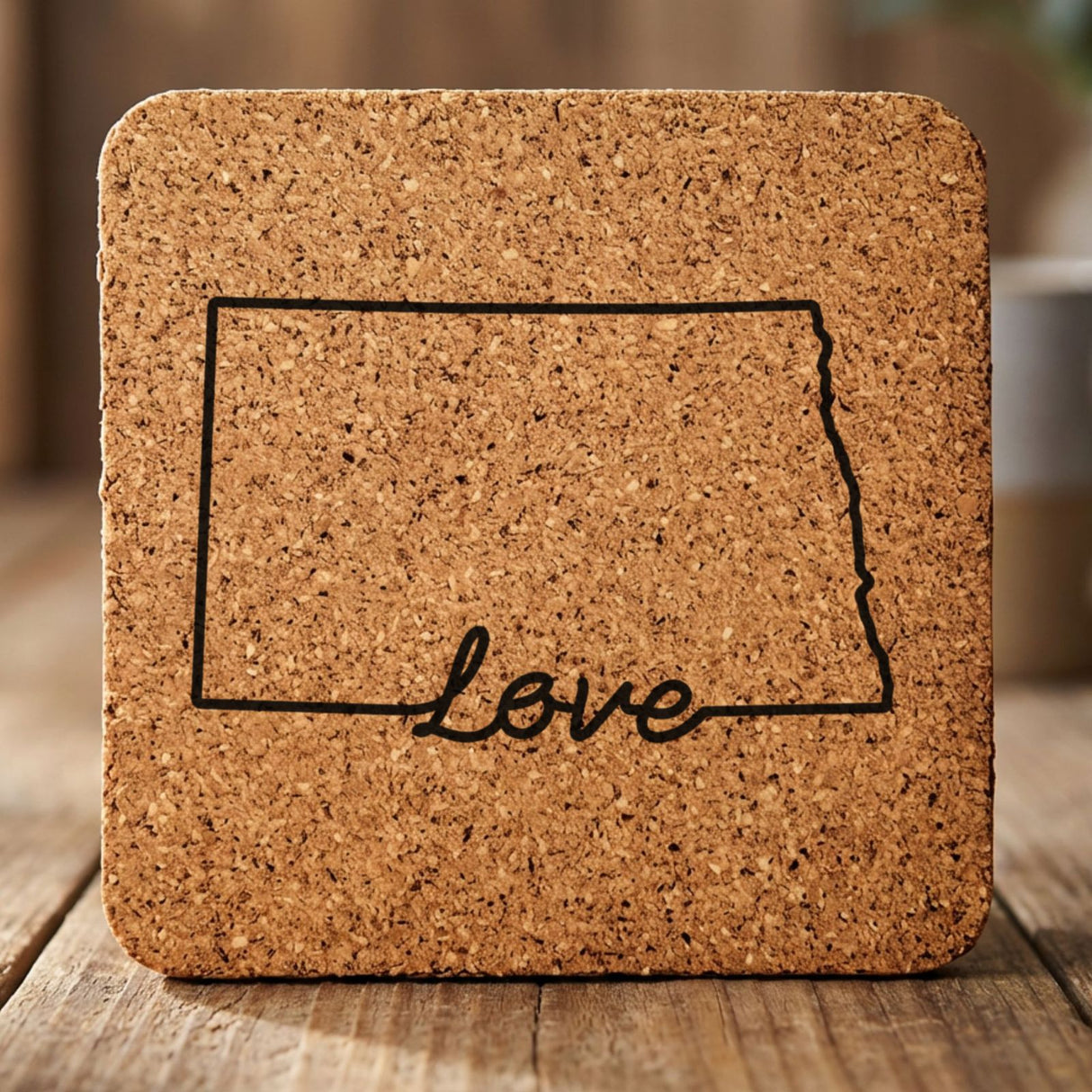 North Dakota square cork coaster engraved with a hand-drawn state outline and love in cursive