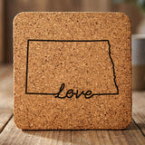 North Dakota square cork coaster engraved with a hand-drawn state outline and love in cursive