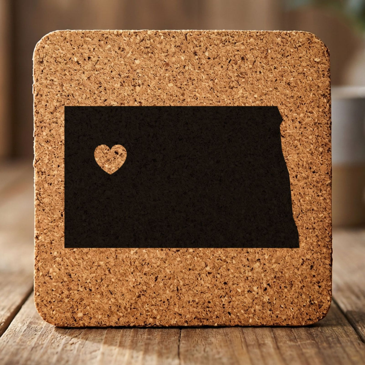 North Dakota square cork coaster engraved with the state shape and a heart