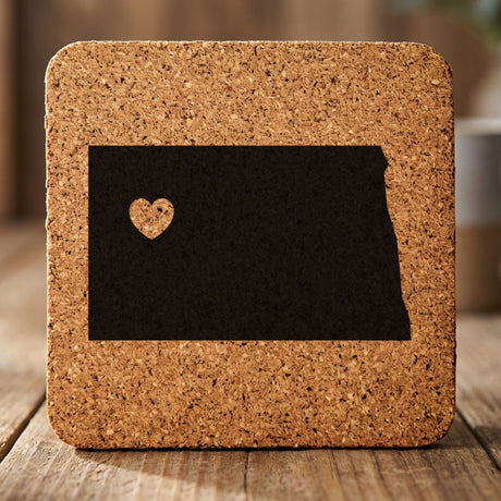 North Dakota square cork coaster engraved with the state shape and a heart