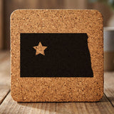 North Dakota square cork coaster engraved with the state shape and a star