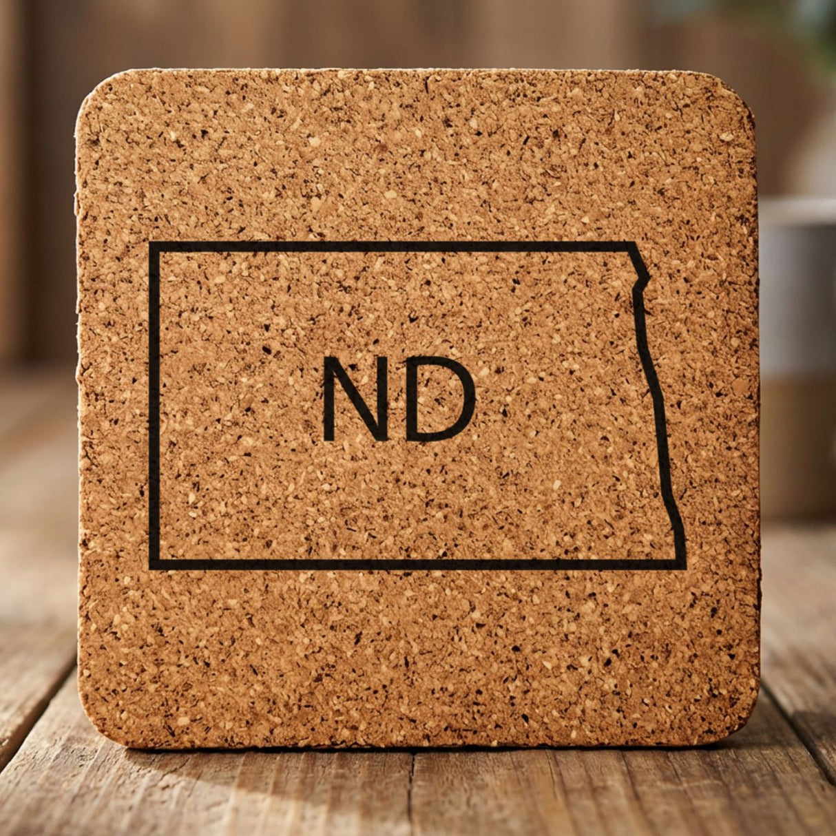 North Dakota square cork coaster engraved with the state outline and ND initials