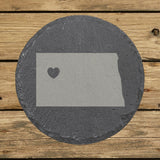 North Dakota round slate coaster engraved with the state shape and a heart