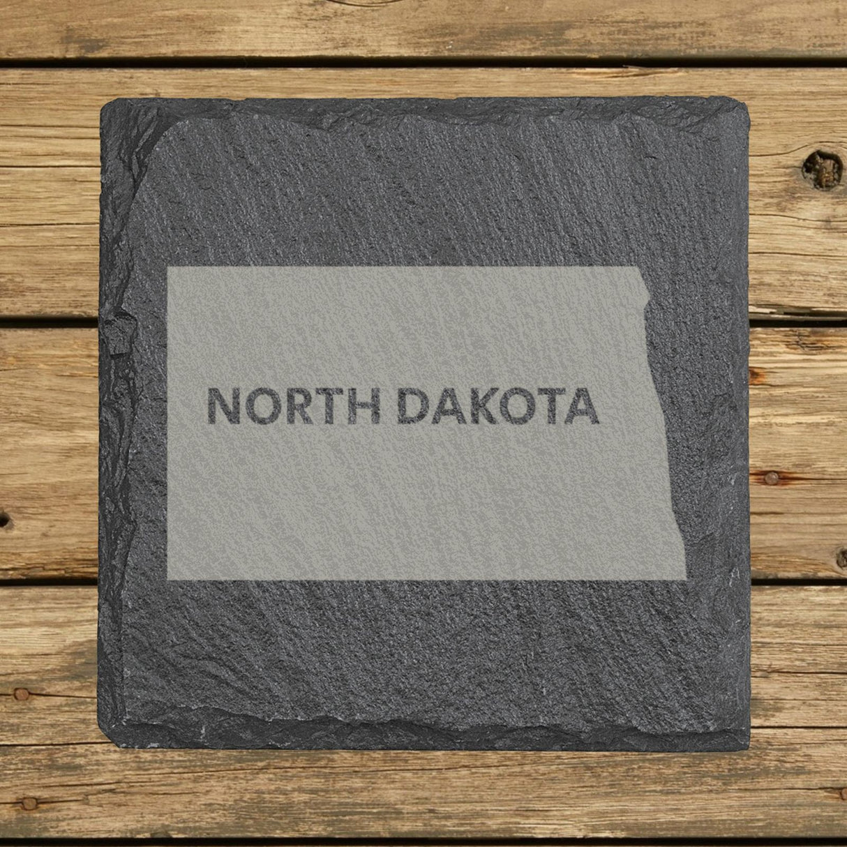 North Dakota square slate coaster engraved with the state shape and NORTH DAKOTA in bold lettering