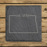 North Dakota square slate coaster engraved with the state outline and est. 1889