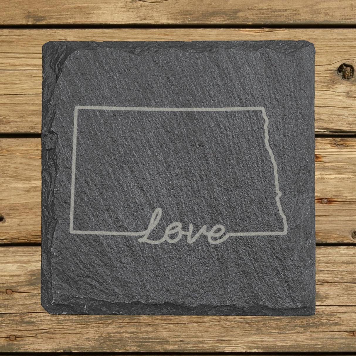 North Dakota square slate coaster engraved with a hand-drawn state outline and love in cursive