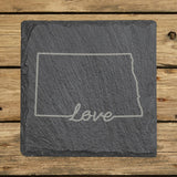 North Dakota square slate coaster engraved with a hand-drawn state outline and love in cursive