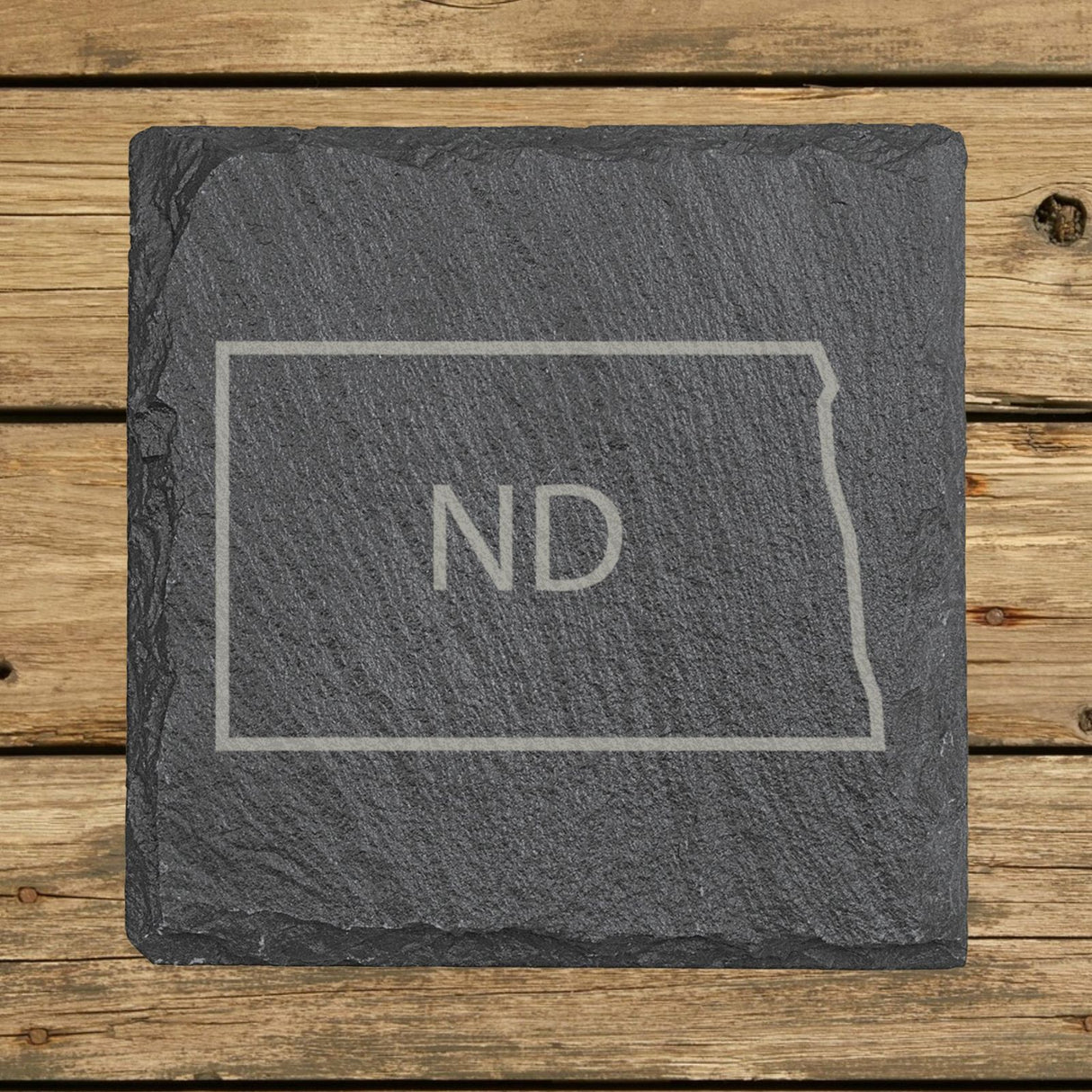 North Dakota square slate coaster engraved with the state outline and ND initials