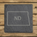 North Dakota square slate coaster engraved with the state outline and ND initials
