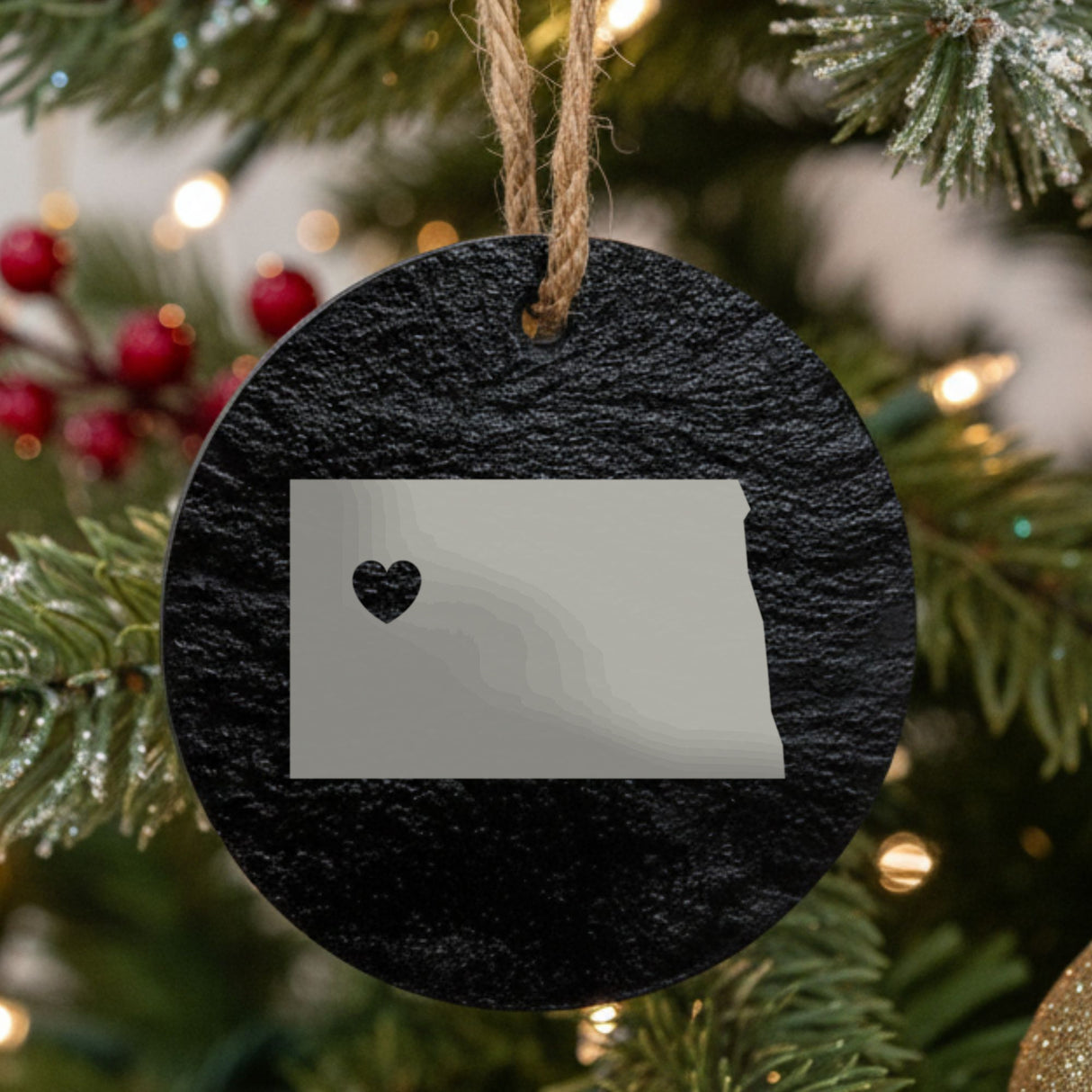 North Dakota round slate Christmas ornament engraved with the state shape and a heart