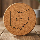 Ohio round cork coaster engraved with the state outline and OHIO in hand-drawn brush lettering