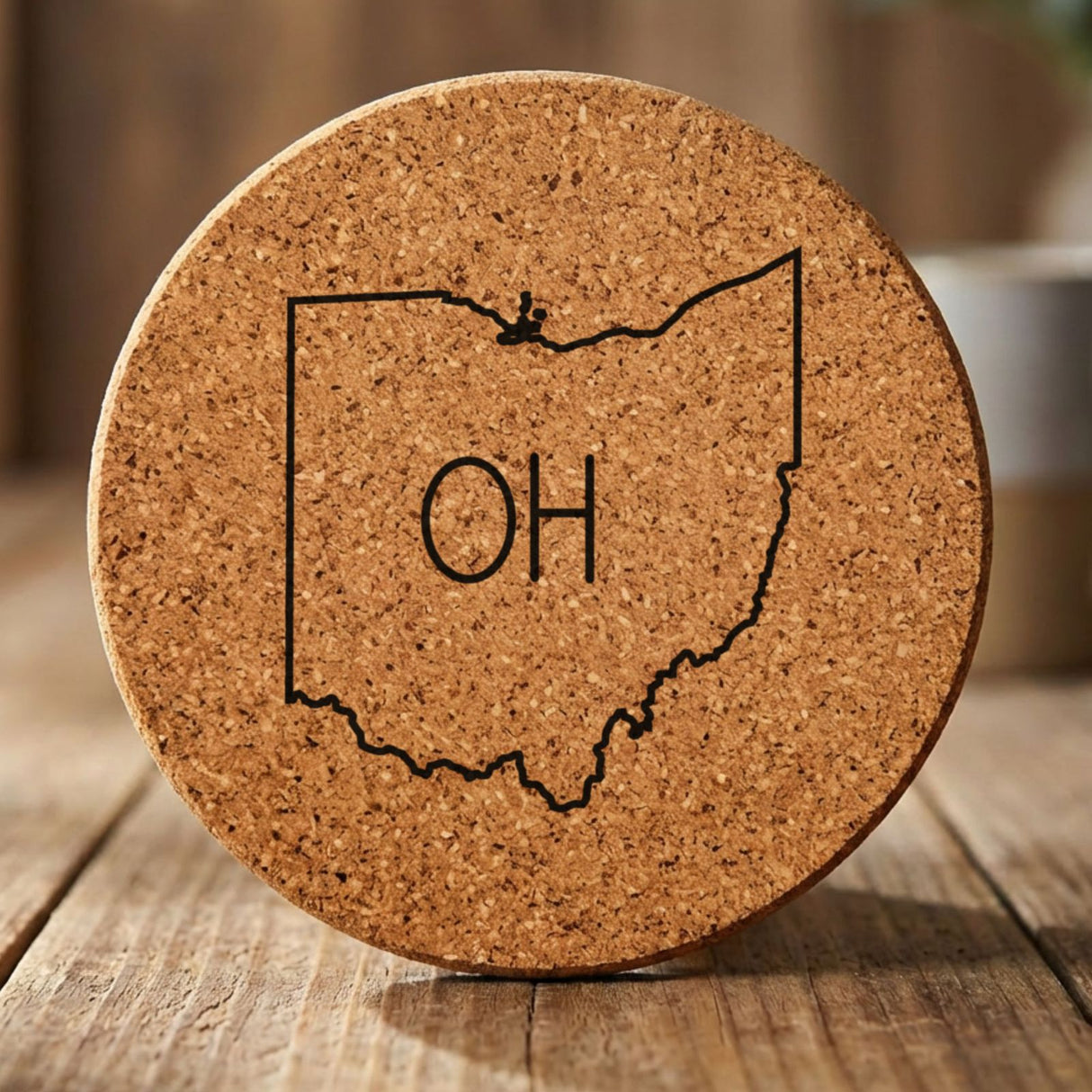 Ohio round cork coaster engraved with the state outline and OH initials