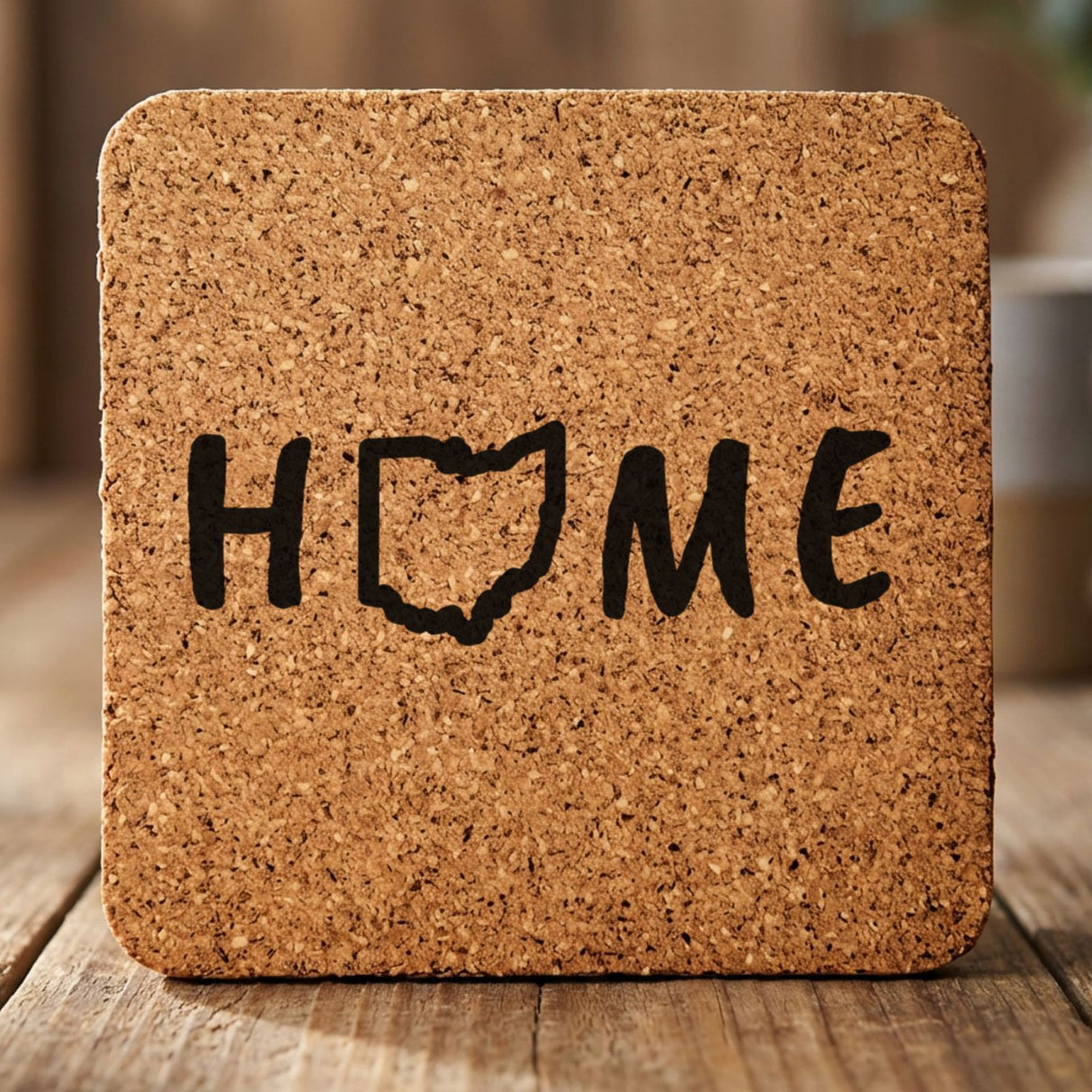 Ohio square cork coaster engraved with HOME using the state outline as the letter O