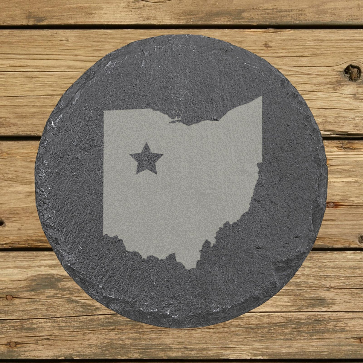 Ohio round slate coaster engraved with the state shape and a star