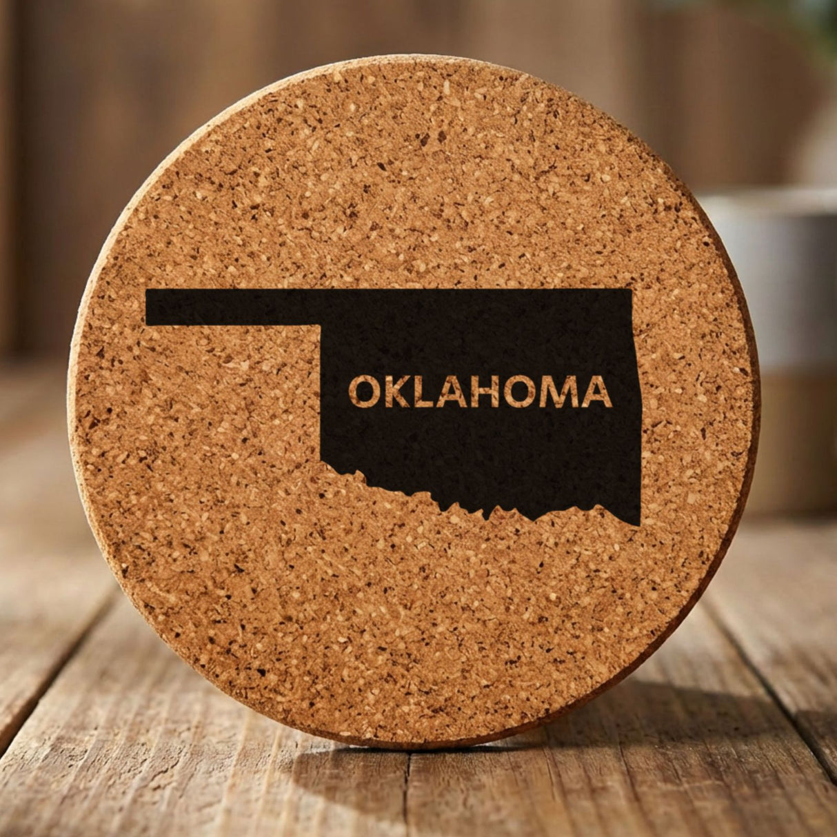 Oklahoma round cork coaster engraved with the state shape and OKLAHOMA in bold lettering