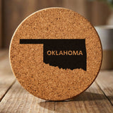 Oklahoma round cork coaster engraved with the state shape and OKLAHOMA in bold lettering
