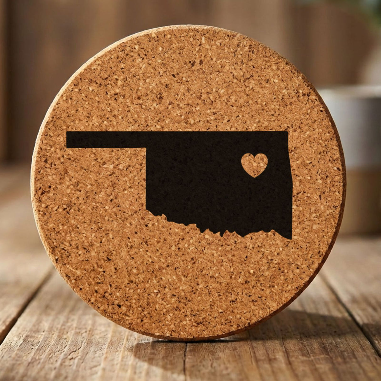 Oklahoma round cork coaster engraved with the state shape and a heart