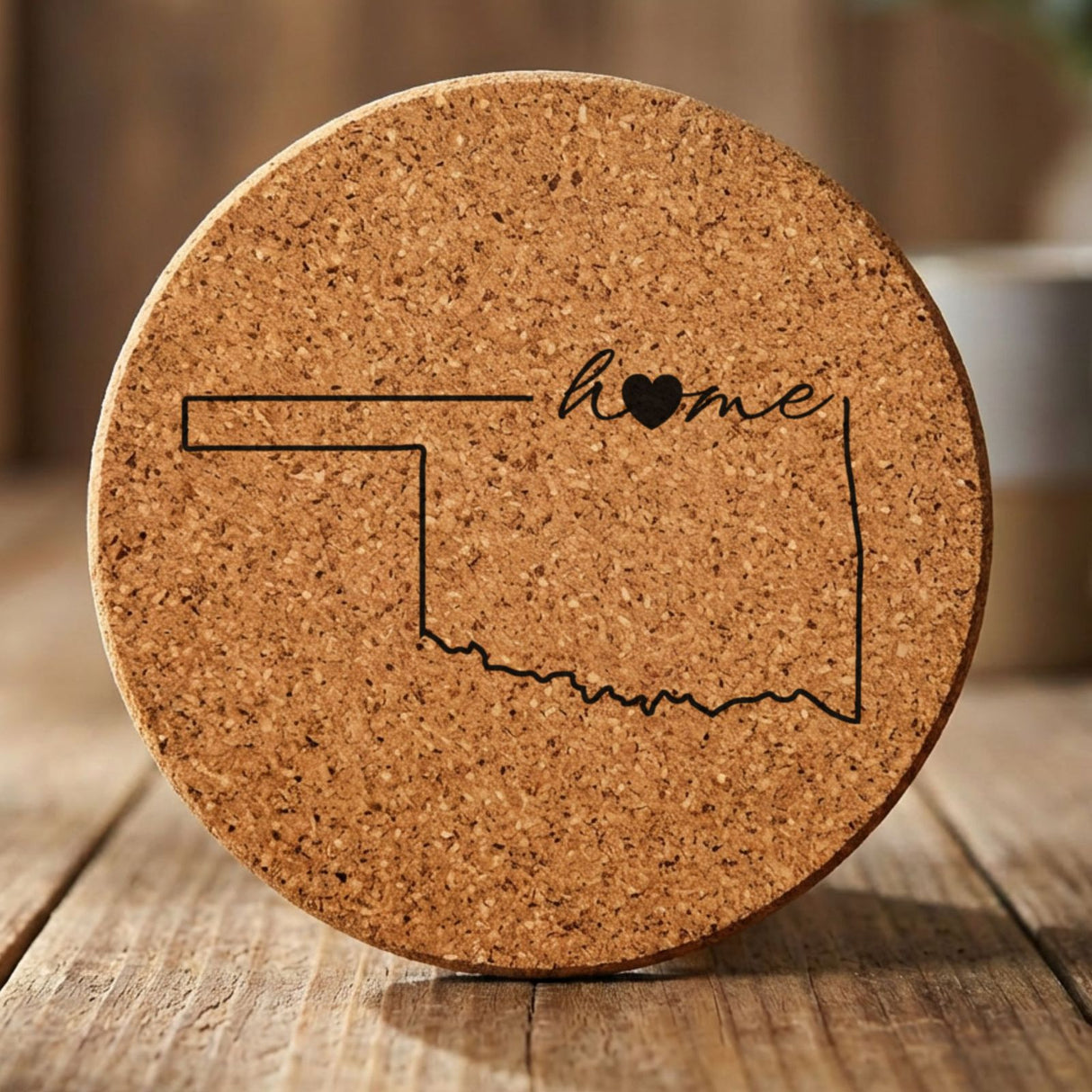 Oklahoma round cork coaster engraved with the state outline and home in script with a heart