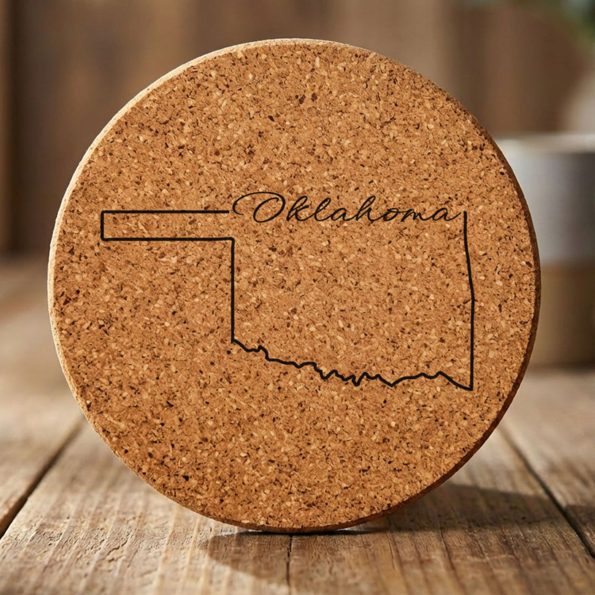 Oklahoma round cork coaster engraved with the state outline and Oklahoma in script lettering