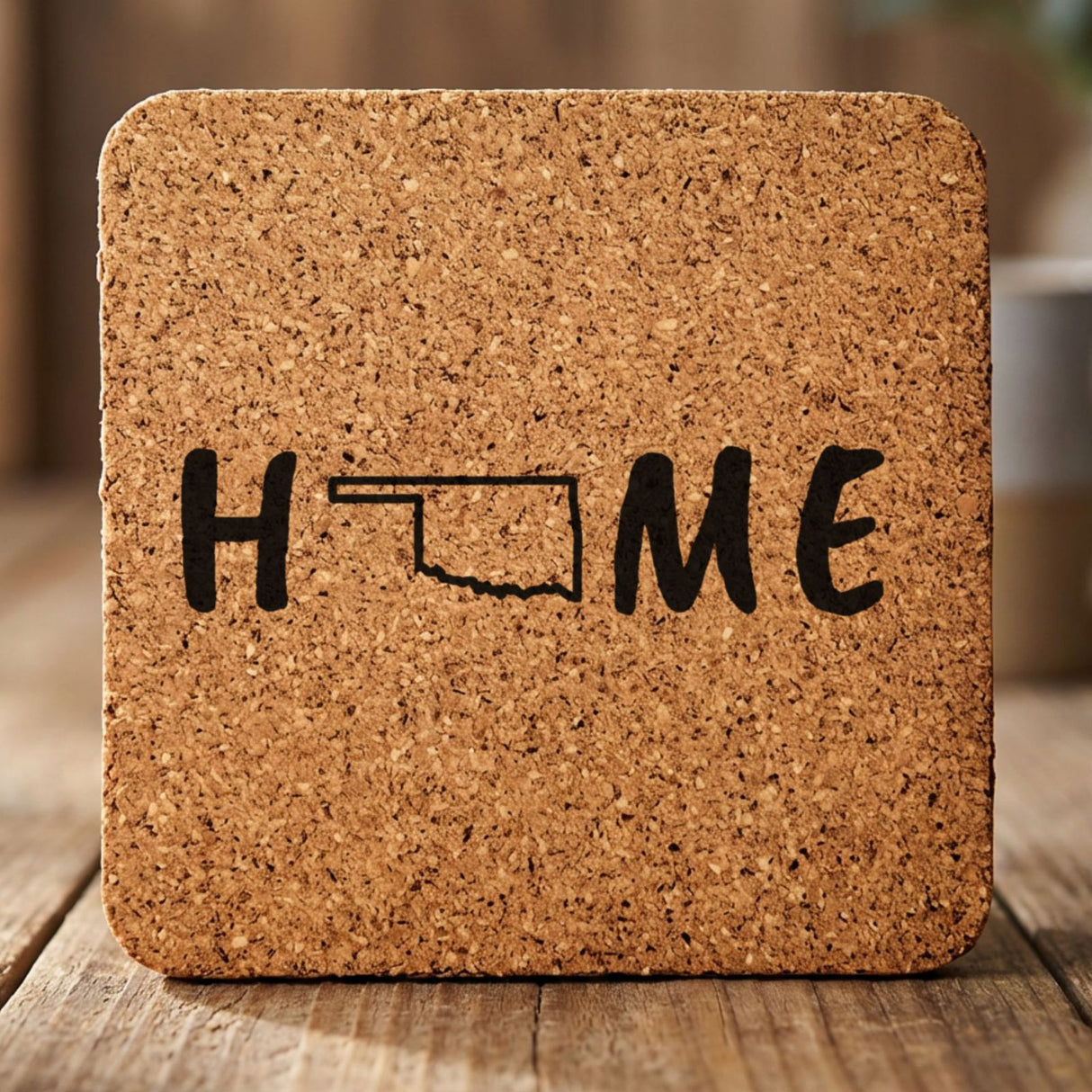 Oklahoma square cork coaster engraved with HOME using the state outline as the letter O