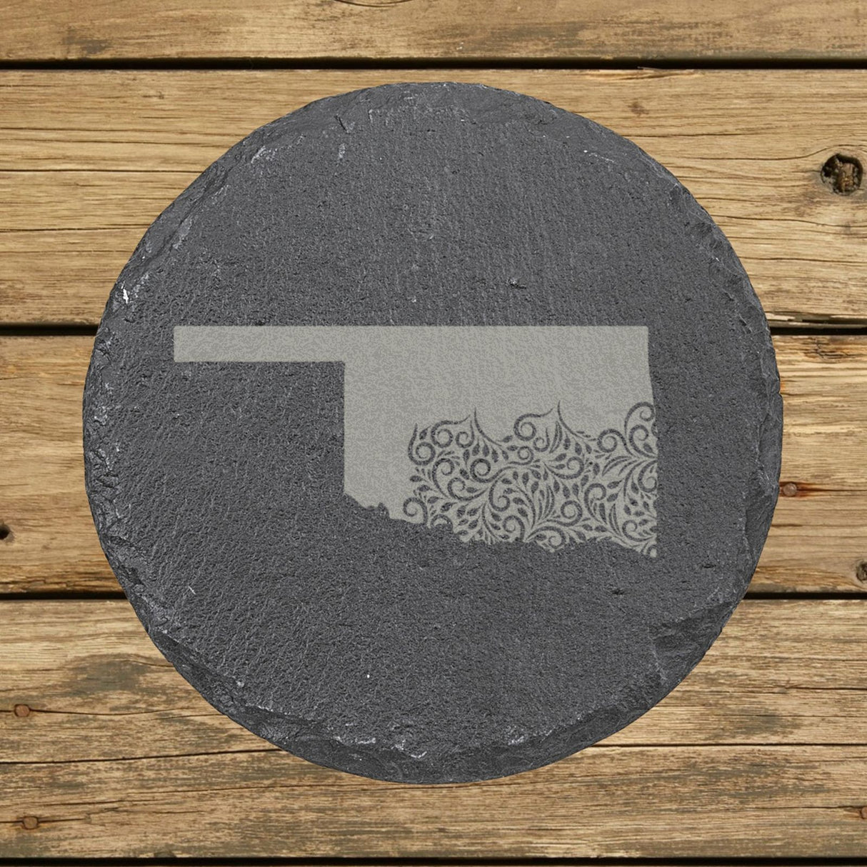 Oklahoma round slate coaster engraved with the state shape in ornate floral scrollwork