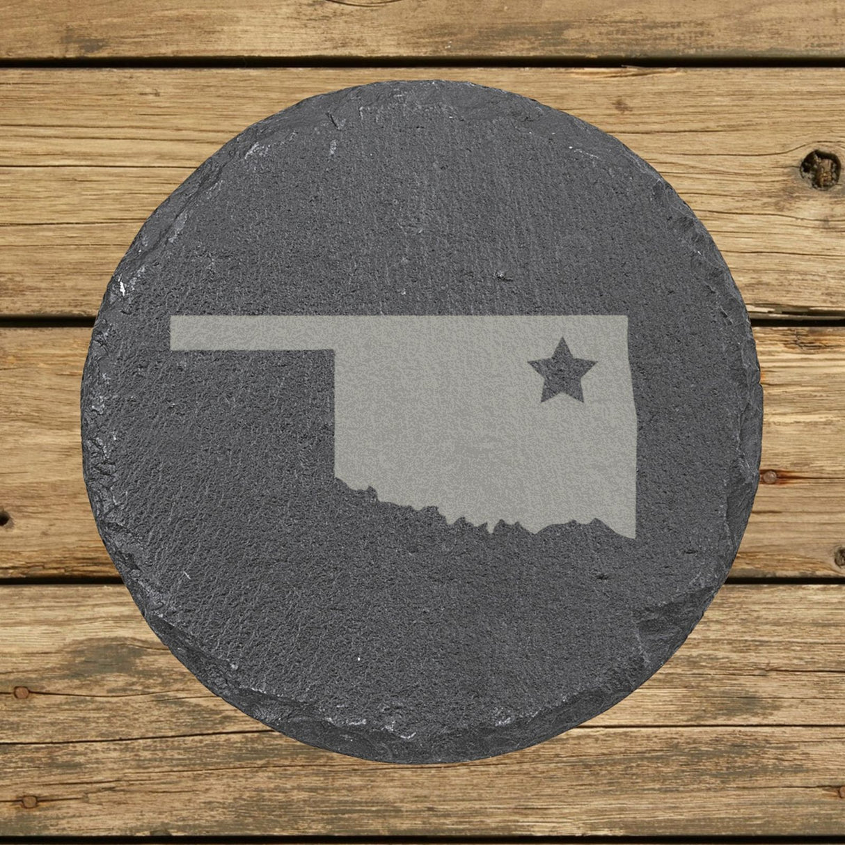 Oklahoma round slate coaster engraved with the state shape and a star