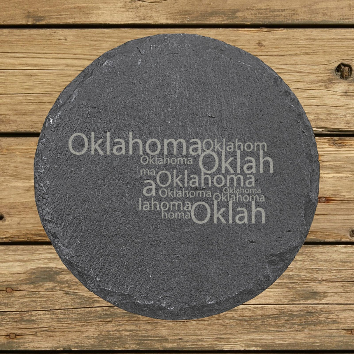 Oklahoma round slate coaster engraved with a word cloud of repeating Oklahoma text