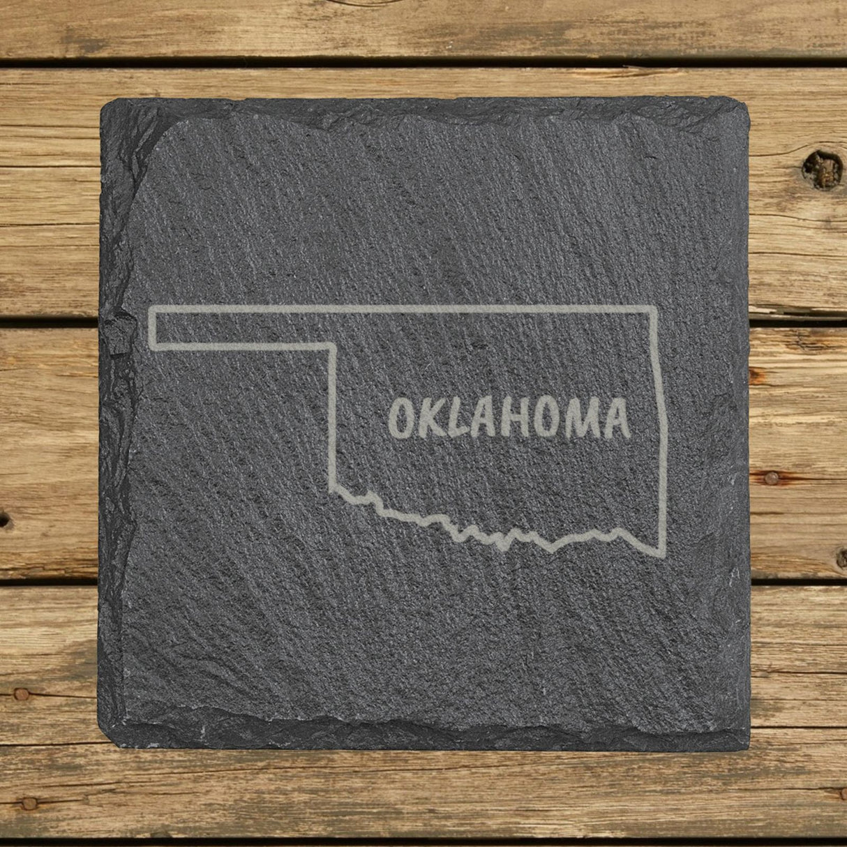 Oklahoma square slate coaster engraved with the state outline and OKLAHOMA in hand-drawn brush lettering
