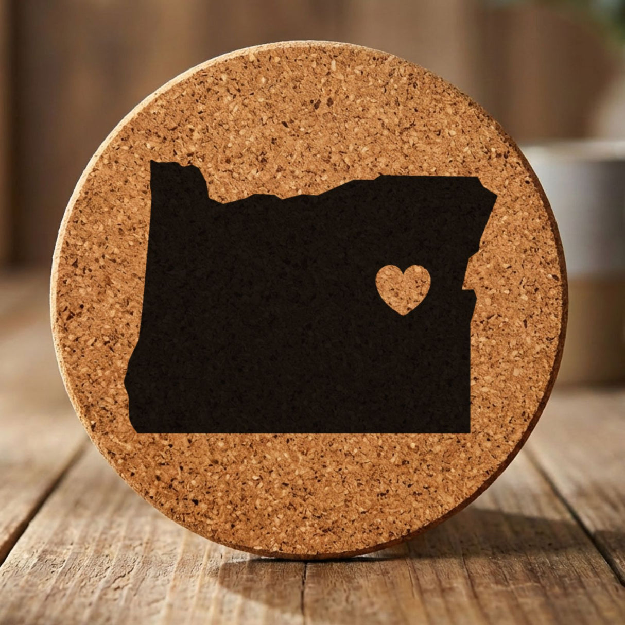 Oregon round cork coaster engraved with the state shape and a heart