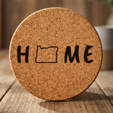 Oregon round cork coaster engraved with HOME using the state outline as the letter O