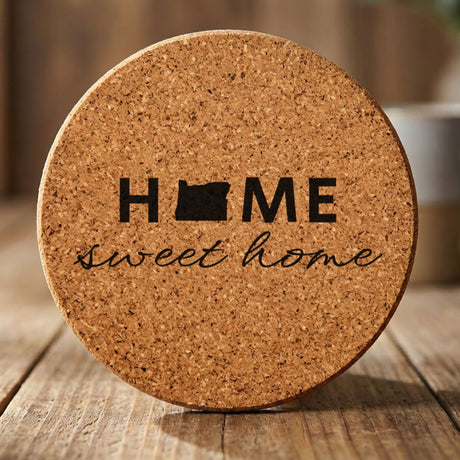 Oregon round cork coaster engraved with HOME sweet home using the state shape as the letter O
