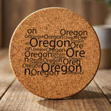 Oregon round cork coaster engraved with a word cloud of repeating Oregon text