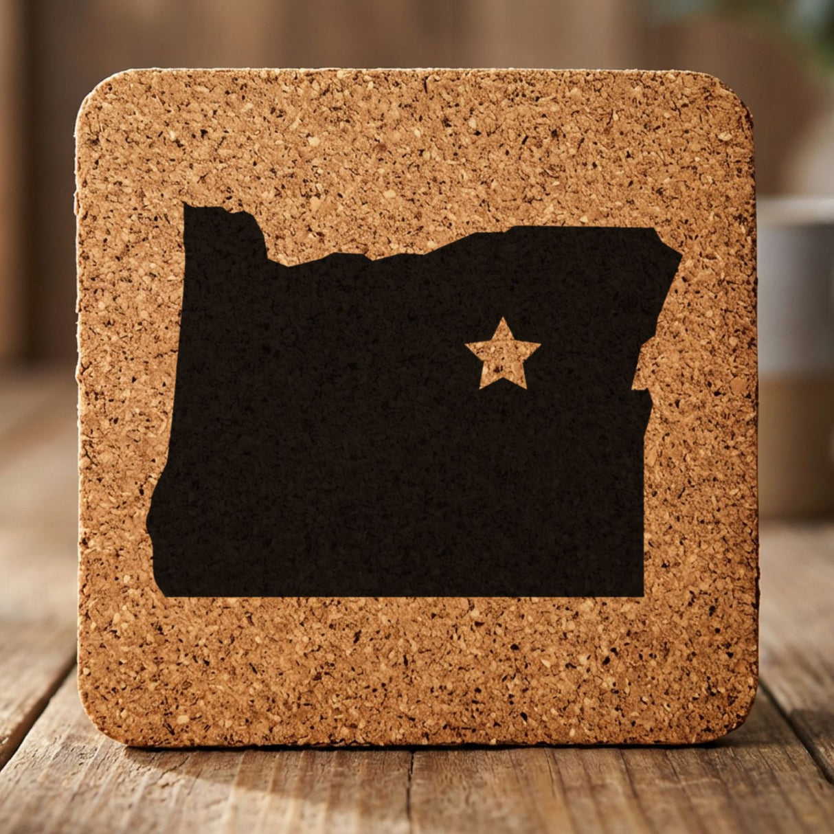 Oregon square cork coaster engraved with the state shape and a star