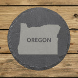 Oregon round slate coaster engraved with the state shape and OREGON in bold lettering
