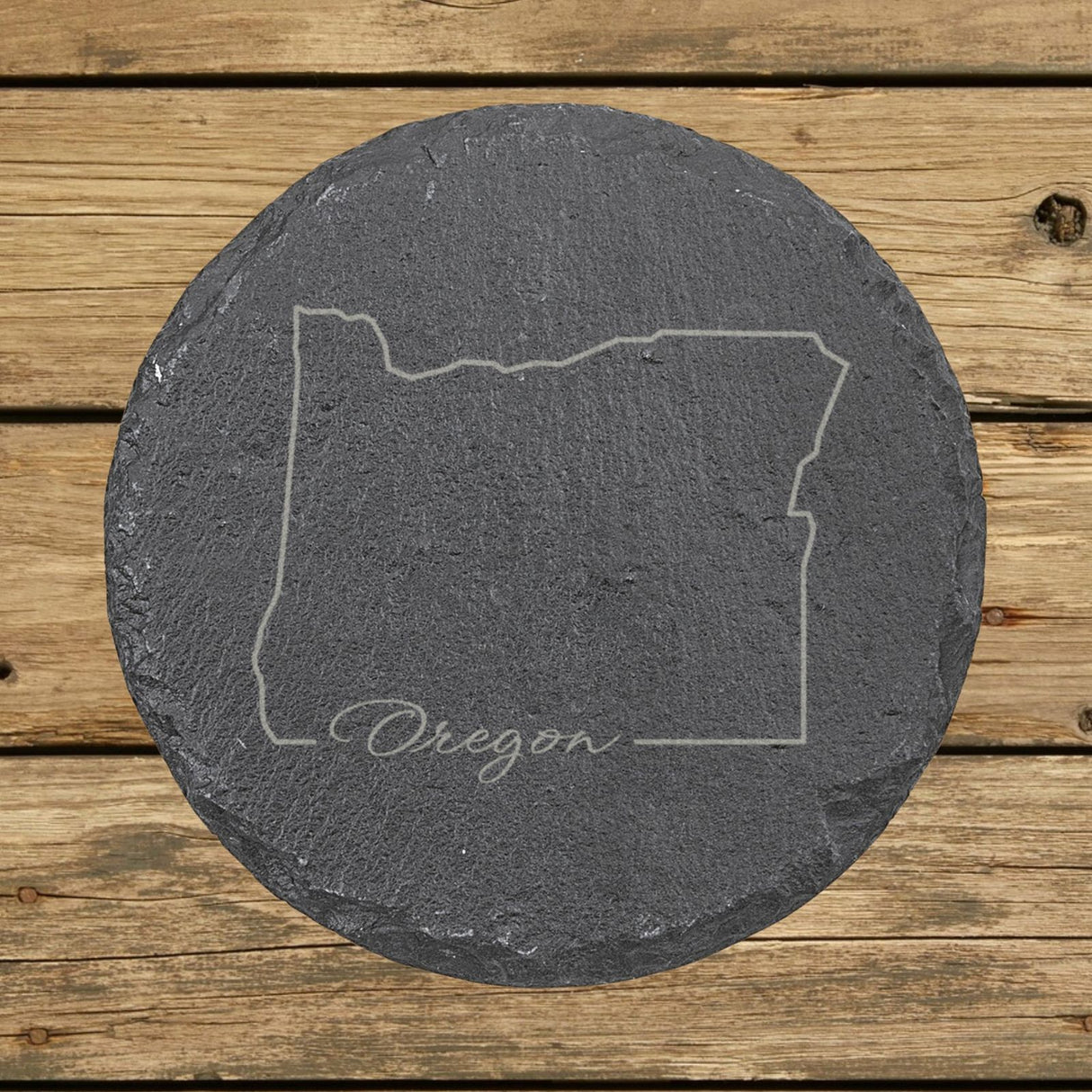 Oregon round slate coaster engraved with the state outline and Oregon in script lettering