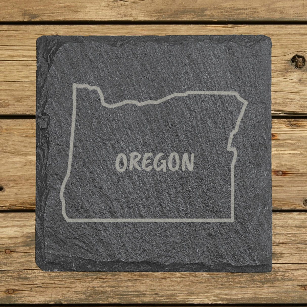 Oregon square slate coaster engraved with the state outline and OREGON in hand-drawn brush lettering