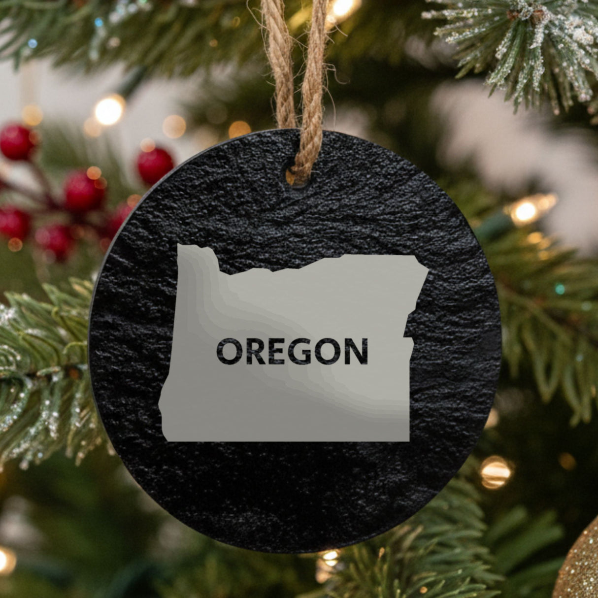 Oregon round slate Christmas ornament engraved with the state shape and OREGON in bold lettering