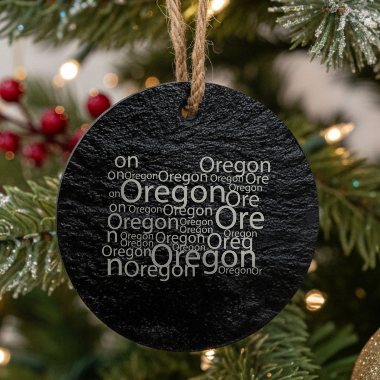 Oregon round slate Christmas ornament engraved with a word cloud of repeating Oregon text