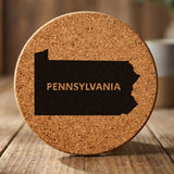 Pennsylvania round cork coaster engraved with the state shape and PENNSYLVANIA in bold lettering