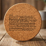 Pennsylvania round cork coaster engraved with a word cloud of repeating Pennsylvania text