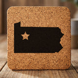 Pennsylvania square cork coaster engraved with the state shape and a star