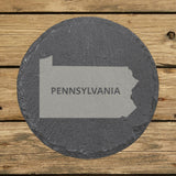 Pennsylvania round slate coaster engraved with the state shape and PENNSYLVANIA in bold lettering
