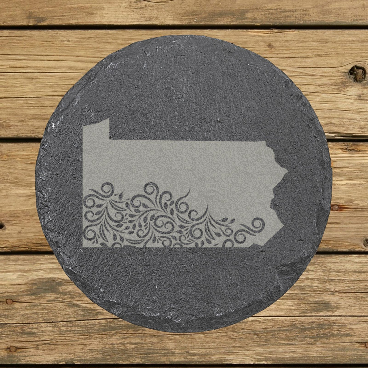 Pennsylvania round slate coaster engraved with the state shape in ornate floral scrollwork