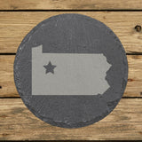 Pennsylvania round slate coaster engraved with the state shape and a star