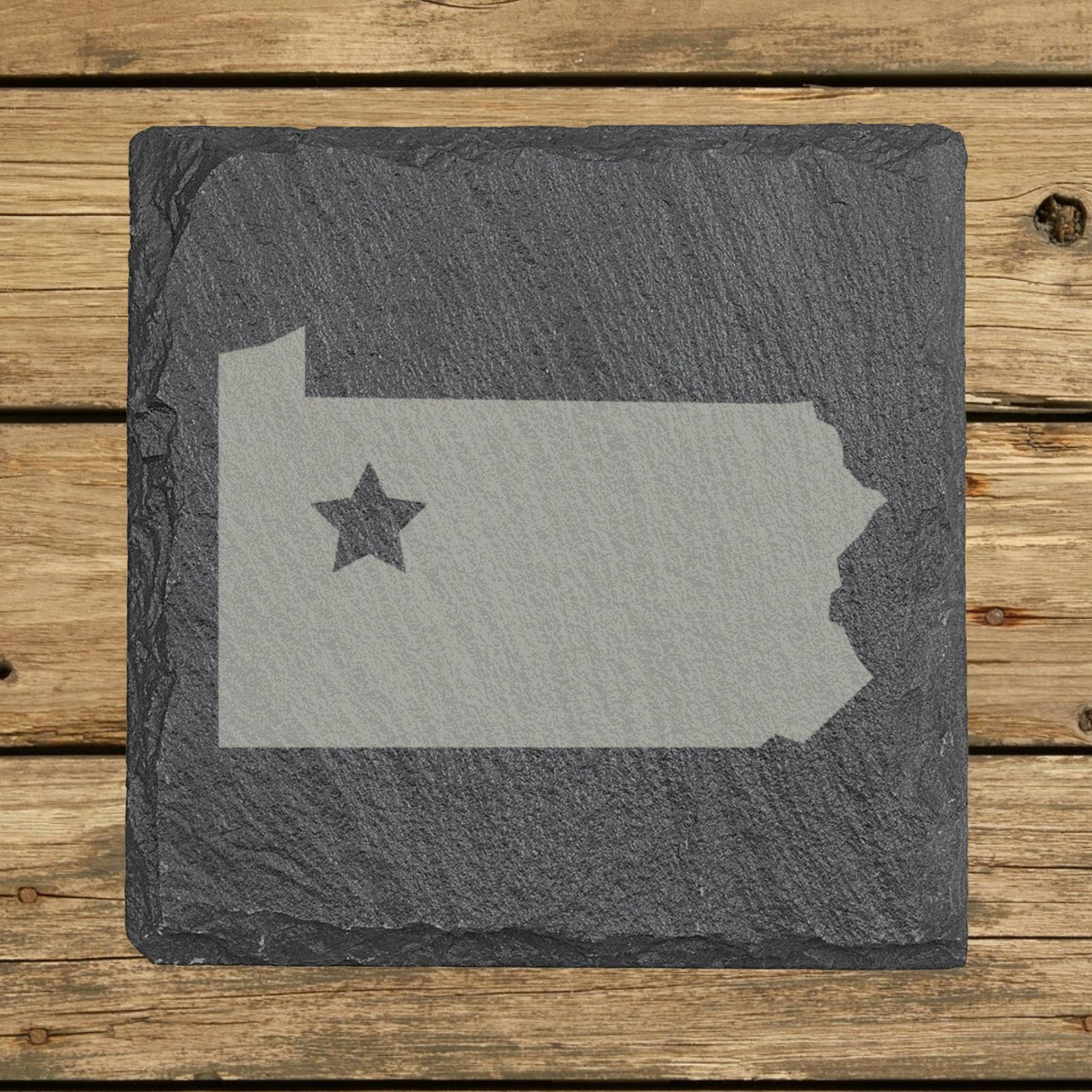 Pennsylvania square slate coaster engraved with the state shape and a star
