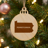 Pennsylvania round wood Christmas ornament engraved with the state shape and PENNSYLVANIA in bold lettering
